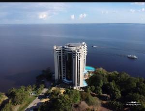 an aerial view of a building in the middle of the water at Tropical executive vista Rio in Manaus