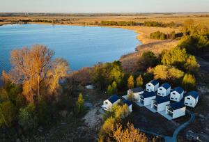 an aerial view of a house next to a body of water at Białe Tarasy in Rogowo