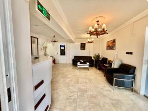 a living room with a couch and a table at THE BEACH SUN OTEL DİDiM in Didim