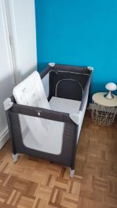 a black and white bed in a room with a table at CoeurDeSable - Appartement T3 Hyper Centre Arcachon - Parking in Arcachon