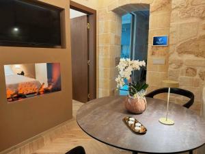 a dining room with a table and a fireplace at Victory Suite in Monopoli
