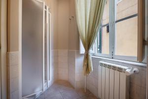 a bathroom with a window and a radiator at Modern Apartments in Palestrina +33 photos