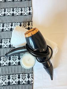 a candle and a cup on a towel at Enjoy apartment & Enjoy room in Porto Torres