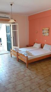 a bedroom with a large bed in a room at Elli Marina Studios & Apts Benitses Mare in Benitses