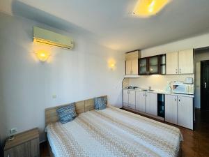 a bedroom with a large bed in a room at SAINT ELENA APART COMPLEX 47 Studio in Sunny Beach