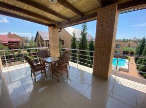 a patio with a table and chairs on a balcony at Admiral 2 in Koblevo