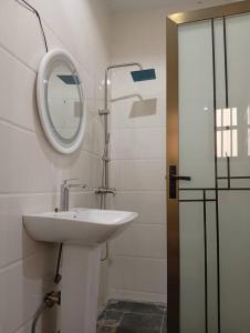 a bathroom with a sink and a mirror at Lamaisu Homes Block 3 in Abuja