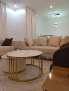 a living room with a couch and a coffee table at Lamaisu Homes Block 3 in Abuja