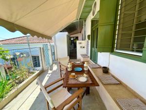 a patio with a table and chairs on a balcony at CapeVerde in Glóssa +28 photos