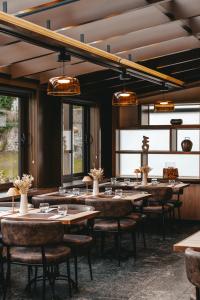 a dining room with tables and chairs and lights at Le Saint Georges in Gruyères