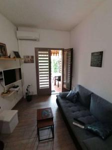 a living room with a couch and a table at Rez-de-jardin proche plage in Cavalaire-sur-Mer