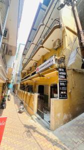 a building with a sign on the side of it at Hotel Laxman Ganga in Rishīkesh