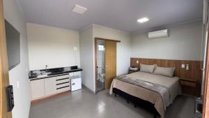 a bedroom with a bed and a sink in it at Lofts Clariô in Alto Paraíso de Goiás