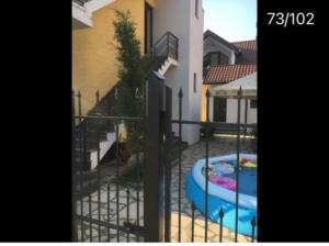 a gate with a pool inside of a building at Come here in Kuchkisabano