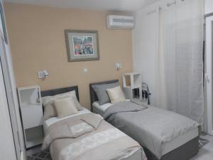 una camera da letto con due letti e una finestra di Jozić Sobe Studio a Krk
