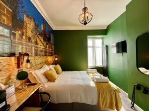 a green bedroom with a bed and a desk at The Crescent Guest House in York