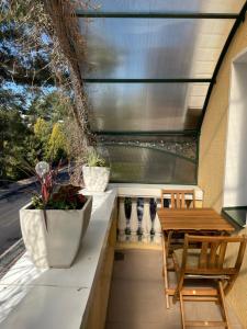a patio with a table and two chairs and a table and a table at Vila Valdonė in Palanga