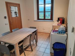 a dining room with a wooden table and chairs at Rifugio Escursionistico Valdivilla in Santo Stefano Belbo
