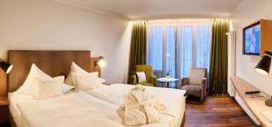 Postel nebo postele na pokoji v ubytování Hotel Villa Hügel