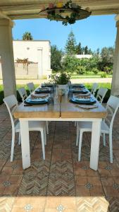 a wooden table with plates and dishes on it at Oleum in Mesagne