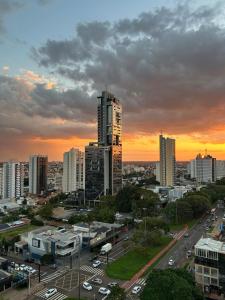 a view of a city with a sunset at Studio Vista Dourada in Campo Grande