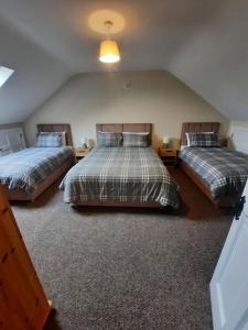 En eller flere senger på et rom på Clone manor Lodge