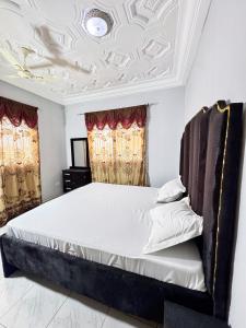 a bedroom with a bed with a coffered ceiling at Paradise Holiday home in Busumbala