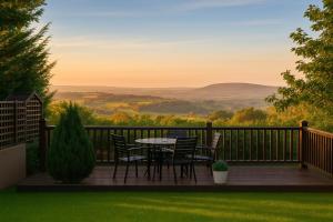 a deck with chairs and a table with a view at Newry Premium B&B in Newry