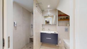 a bathroom with a sink and a toilet and a tub at Mon petit chez soi en Alsace in Rountzenheim