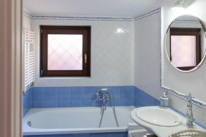 a bathroom with a tub and a sink and a mirror at Mare Amore Fantasia in Gaeta +20 photos