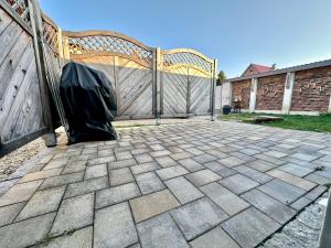 a patio with a fence and a wooden gate at Ferienwohnung Gerdi in Hoyerswerda