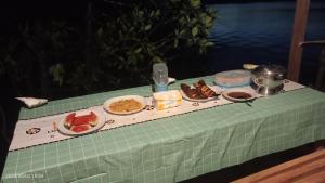 a table topped with plates of food on a table at Ombar Guest House in Minyaifuin