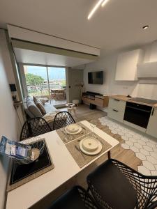 a kitchen and living room with a table and chairs at L'Original in Hyères