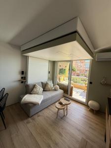 a living room with a couch and a large window at L'Original in Hyères