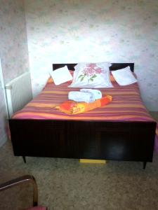 a bed with two pillows on top of it at Chambre de la baronne de Rochegrosse in Saint-Maurice-en-Gourgois