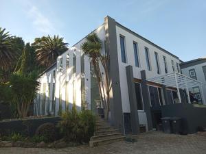 a building with palm trees in front of it at Retro Boutique in Cape Town