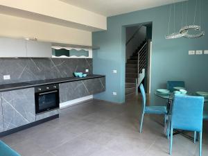 a kitchen with a counter and a table and chairs at Polinesia 11 in Lido delle Nazioni
