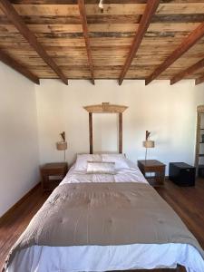 a bedroom with a large bed with wooden ceilings at Casa Antigua Bed and Breakfast in Casablanca +22 photos