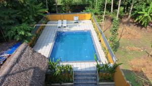 an overhead view of a swimming pool in a garden at Swargam Pool Resort in Varkala
