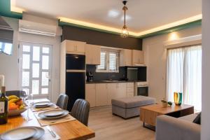 a kitchen and living room with a table and a dining room at ikosapartments-family in Pérdika