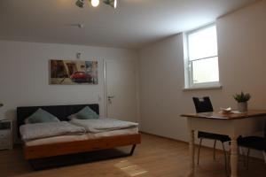 a bedroom with a bed and a desk and a table at Casa Parla in Rust