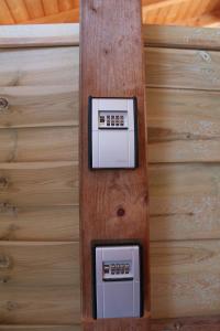 two electrical devices on a wooden wall at Casa Parla in Rust