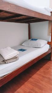 two bunk beds with white sheets and pillows on them at Hostel Flamengo in Rio de Janeiro +17 photos