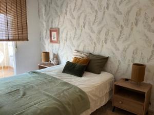 sypialnia z łóżkiem i poduszkami w obiekcie Apto Calpe con piscina. No uses coche vacaciones. w mieście Calpe