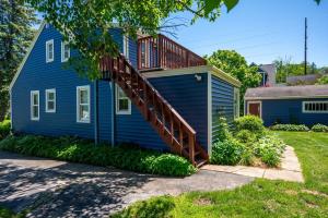 een blauw huis met een terras aan de zijkant bij Hudson Ave Loft in Sturgeon Bay