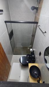 a bathroom with a black toilet and a mirror at MOTO Inn URUBICI in Urubici +34 photos