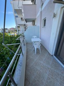 a balcony of a building with a table on it at Villa Noah in Ksamil