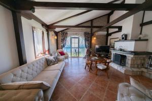 a living room with a couch and a table at Villa Rustique in Budva