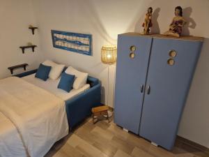 a bedroom with a bed and a blue cabinet at Appartamento I TRE SANTI in Bisceglie