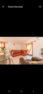 a room with two beds and a table and a couch at Apartman Alar in Pridraga +3 photos